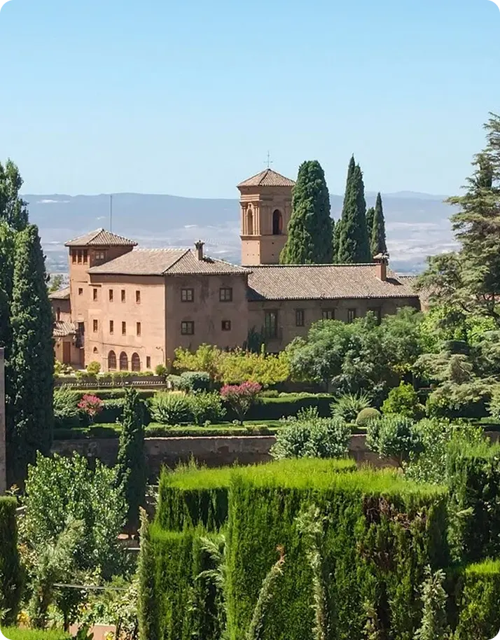 . A prominent building overlooks a wide garden area,