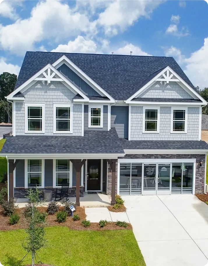 A gray home featuring two garages