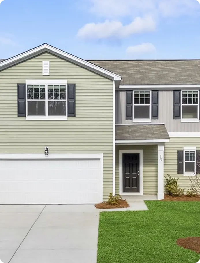 A two-story house with a garage and a driveway