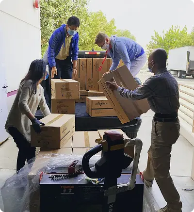 People are actively loading boxes into a truck