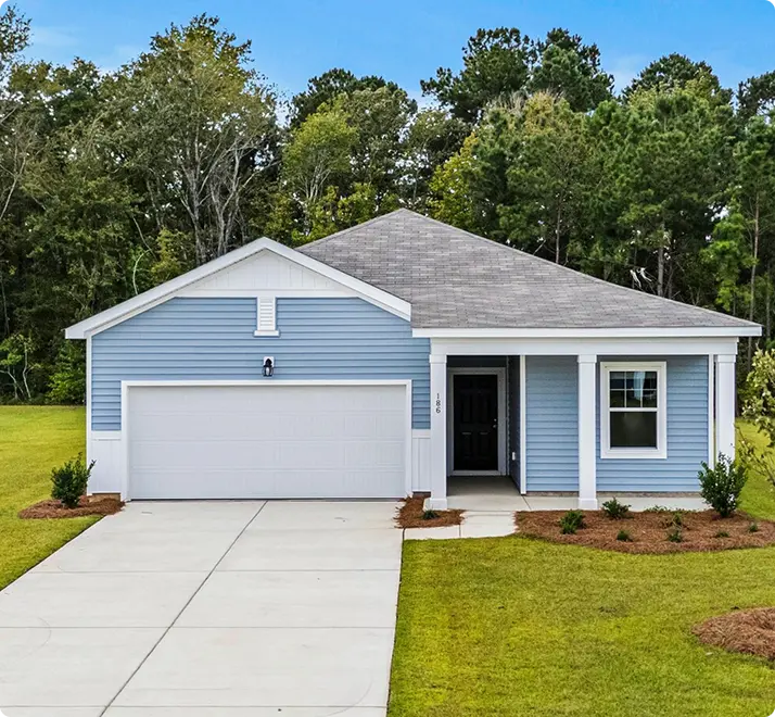 A blue house featuring a garage and a driveway